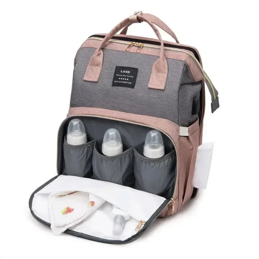 Multifunctional maternity bag - backpack with changing area and foldable portable crib.