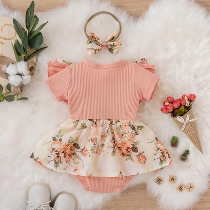 Girls' pink jumpsuit dress with front bow - floral and striped print for summer.