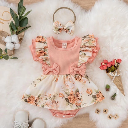 Girls' pink jumpsuit dress with front bow - floral and striped print for summer.