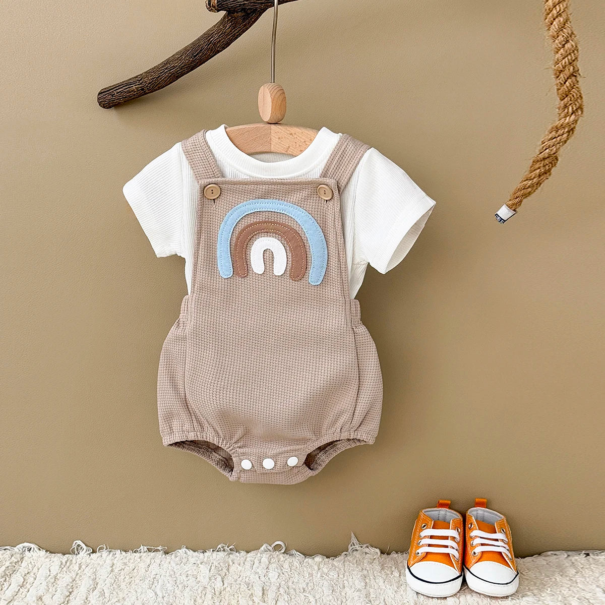Children's summer outfit - suspender jumpsuit with striped t-shirt and rainbow patch.