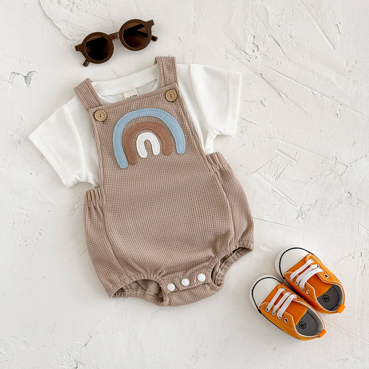 Children's summer outfit - suspender jumpsuit with striped t-shirt and rainbow patch.